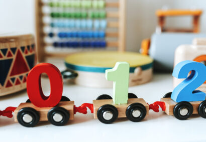 Set of kid toys on a white shelf